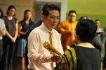 Kim Cheng passing on the baton to David Ho
